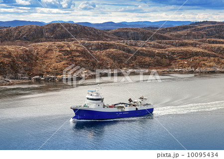Blue Norwegian fish carrier ship passes through the fjord Blue Norwegian fish carrier ship passes through the fjord 10095434