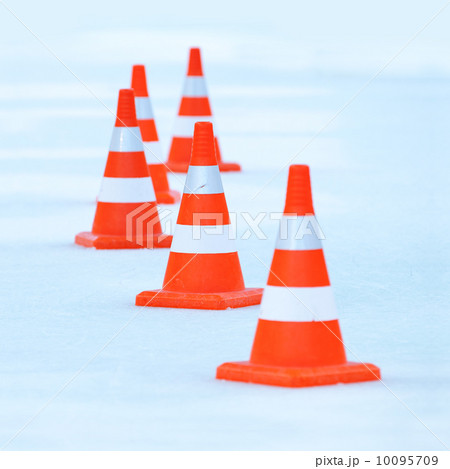 Red and white striped cones on the ice 10095709