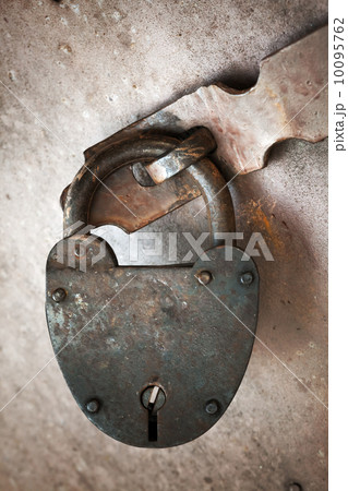 Old rusted lock hangs on metal door. Close-up photo Old rusted lock hangs on metal door. Close-up photo 10095762