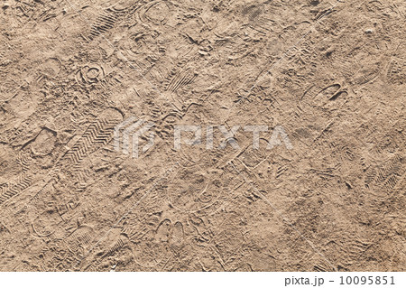 Sandy pedestrian lane with different footprints. Background photo texture 10095851