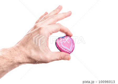 Handmade pink painted heart shaped stone in man's hand isolated on white Handmade pink painted heart shaped stone in man's hand isolated on white 10096013