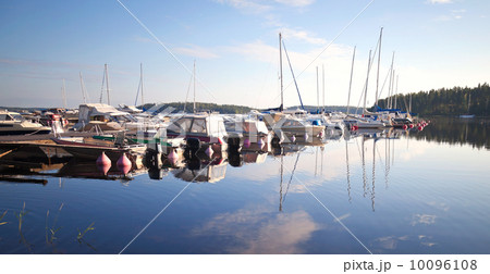 Yachts and motorboats moored in small European marina. Imatra town, Saimaa lake, Finland Yachts and motorboats moored in small European marina. Imatra town, Saimaa lake, Finland 10096108