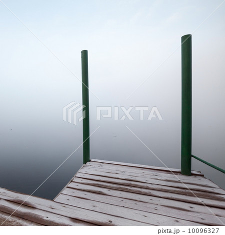 Foggy coastal abstract fragment with frozen wooden pier Foggy coastal abstract fragment with frozen wooden pier 10096327