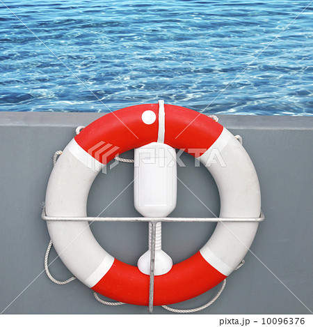Red and white lifebuoy with rope with sea water on a background Red and white lifebuoy with rope with sea water on a background 10096376