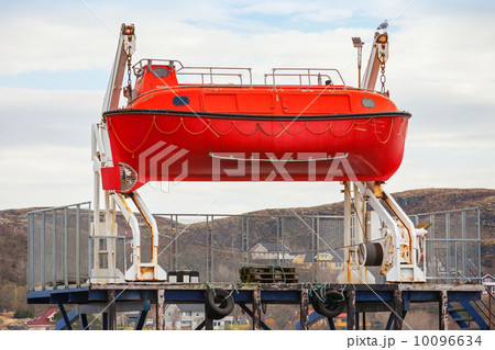 Red rescue boat stands on the coast in Norway 10096634