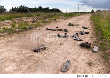 Old rural road with abandoned shoes 10096780