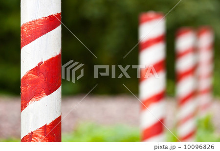 Red and white striped poles in the row Red and white striped poles in the row 10096826