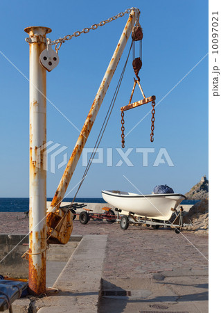White fishing boat and small crane in port of Petrovac town, Mon White fishing boat and small crane in port of Petrovac town, Mon 10097021