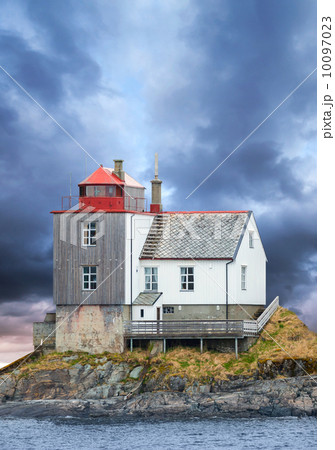 Old Norwegian lighthouse on rocky island with dramatic sky 10097023