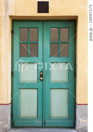 Green wooden door with windows in old building facade. Tallinn, Estonia Green wooden door with windows in old building facade. Tallinn, Estonia 10097173