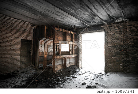 Old grunge abandoned barn interior with glowing exit 10097241