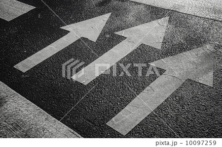 Pedestrian crossing road marking with white arrows on asphalt Pedestrian crossing road marking with white arrows on asphalt 10097259