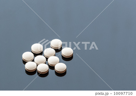 White Pills on Glass Background 10097710