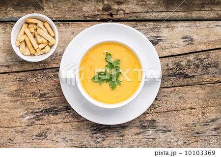 Pea soup with crotons on wood background 10103369