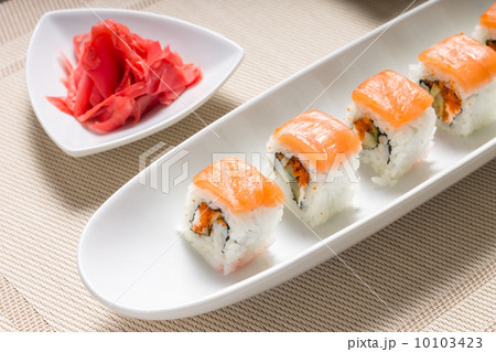 Seafood sushi rolls in white plate with chopsticks and japanese spices Seafood sushi rolls in white plate with chopsticks and japanese spices 10103423