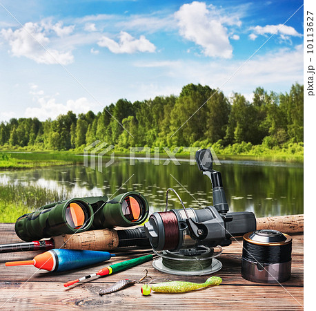 fishing tackle on a pontoon on the background of the lake fishing tackle on a pontoon on the background of the lake 10113627