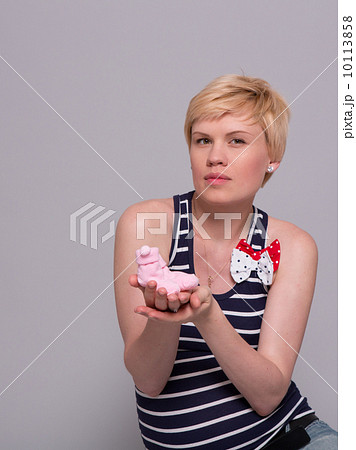happy young pregnant woman holds a pink socks for his daughter happy young pregnant woman holds a pink socks for his daughter 10113858