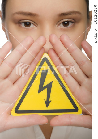 Young woman holding a yellow triangle Young woman holding a yellow triangle 10120250