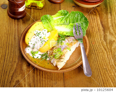 Fish, potato with quark, salad and fork 10125604