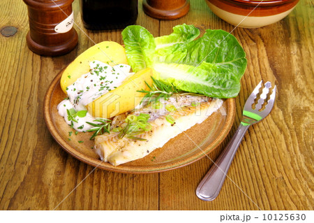 Fish, potato with cottage cheese, salad and fork 10125630