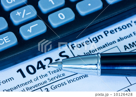 US tax form with pen and calculator US tax form with pen and calculator 10126428
