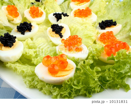 Quail eggs topped with salmon, trout and sturgeon caviar Quail eggs topped with salmon, trout and sturgeon caviar 10131831