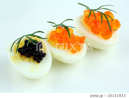 Salmon, trout and sturgeon caviar served on quail eggs Salmon, trout and sturgeon caviar served on quail eggs 10131833