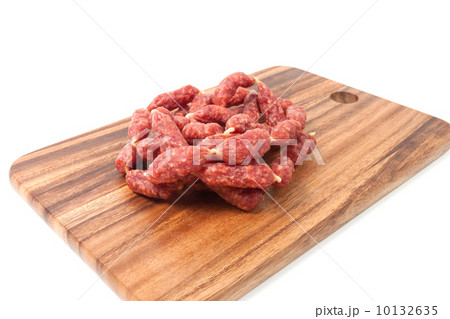 A heap of mini Salamis on wooden board 10132635