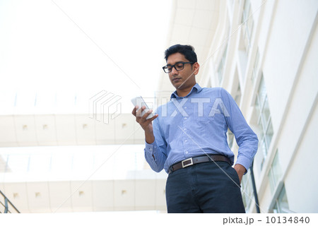 indian business male holding a phone indian business male holding a phone 10134840