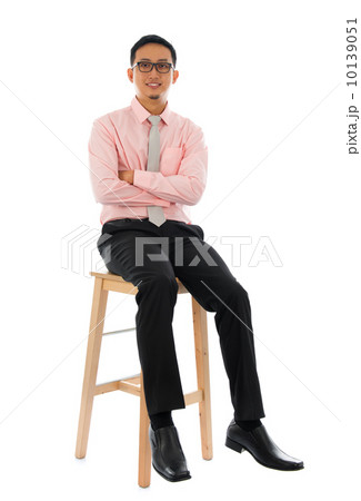 Asian businessman sitting on a wooden chair 10139051