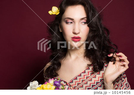 Pretty brunette lady with fresia flowers  10145456