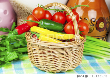 Peppers, tomatoes with spring onions and parsley in basket 10146026