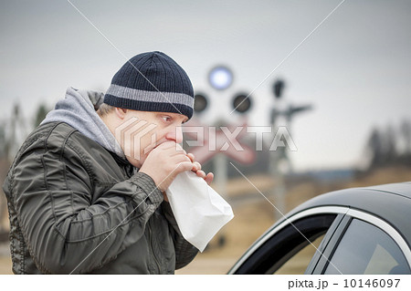Worried man breathe into a paper bag near rail crossing Worried man breathe into a paper bag near rail crossing 10146097
