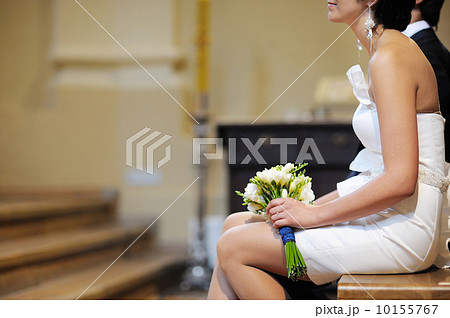 Bride holding flowers at the wedding ceremony 10155767