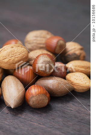 heap of nuts on a wooden surface heap of nuts on a wooden surface 10156686