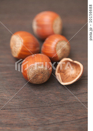 heap of hazelnuts on a wooden surface heap of hazelnuts on a wooden surface 10156688