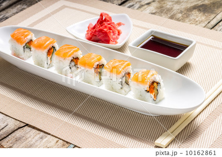 Seafood Sushi rolls in White Long Dish with soy sauce Seafood Sushi rolls in White Long Dish with soy sauce 10162861