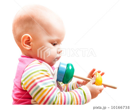 Little brown eyed baby plays with wooden toy, studio profile por 10166738