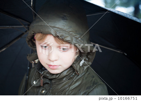 Portrait of a little blond girl with umbrella in a casual jacket 10166751