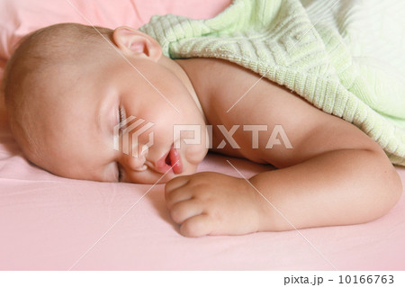 Portrait of Little baby sleeping in the bed under soft green blanket Portrait of Little baby sleeping in the bed under soft green blanket 10166763