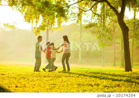 Happy asian family playing on the field Happy asian family playing on the field 10174204