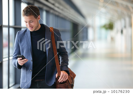 Man on smart phone - young business man in airport 10176230