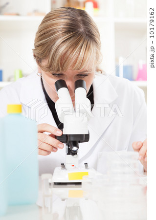 Researcher looking into a microscope in laboratory 10179162