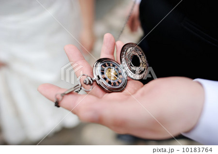 A man holding an antique pocketwatch A man holding an antique pocketwatch 10183764