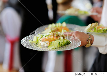 Waitress carrying plates with fish dish 10183833