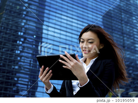 Asian business woman working outdoors with a tablet 10195059