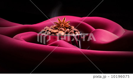 cup of Coffee with beans on red silk 10196075