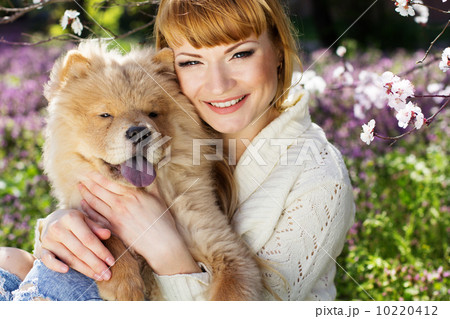 Portrait of a woman with her dog outdoors Portrait of a woman with her dog outdoors 10220412