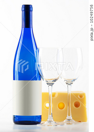Blue bottle of white wine, two wine glasses and cheese 10249756