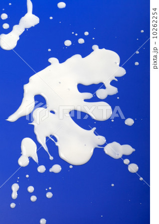 Stains from milk on blue background Stains from milk on blue background 10262254